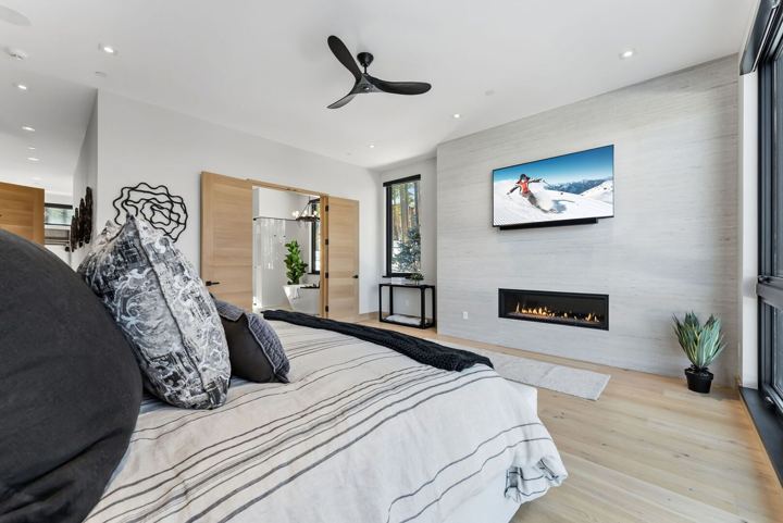 Primary suite with fireplace and mountain-view windows
